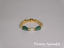 Load image into Gallery viewer, round white pearls with gold spacer beads with the main focus made up of one large white pearl bead surrounded by a thin sparkling bead and green pear shaped pearl 
