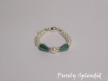 Load image into Gallery viewer, round white pearls with silver spacer beads with the main focus made up of one large white pearl bead surrounded by a thin sparkling bead and green pear shaped pearl 
