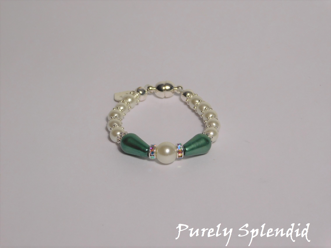 round white pearls with silver spacer beads with the main focus made up of one large white pearl bead surrounded by a thin sparkling bead and green pear shaped pearl 