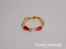 Load image into Gallery viewer, round white pearls with gold spacer beads with the main focus made up of one large white pearl bead surrounded by a thin sparkling bead and red pear shaped pearl 
