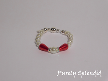 Load image into Gallery viewer, round white pearls with silver spacer beads with the main focus made up of one large white pearl bead surrounded by a thin sparkling bead and red pear shaped pearl 
