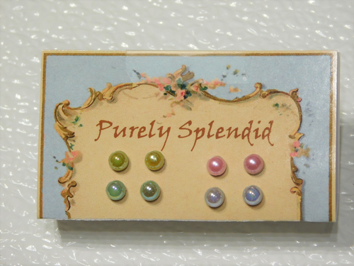 four pairs of iridescent pastel pearl 2mm studs shown on a Purely Splendid presentation card- yellow, pink, green, blue