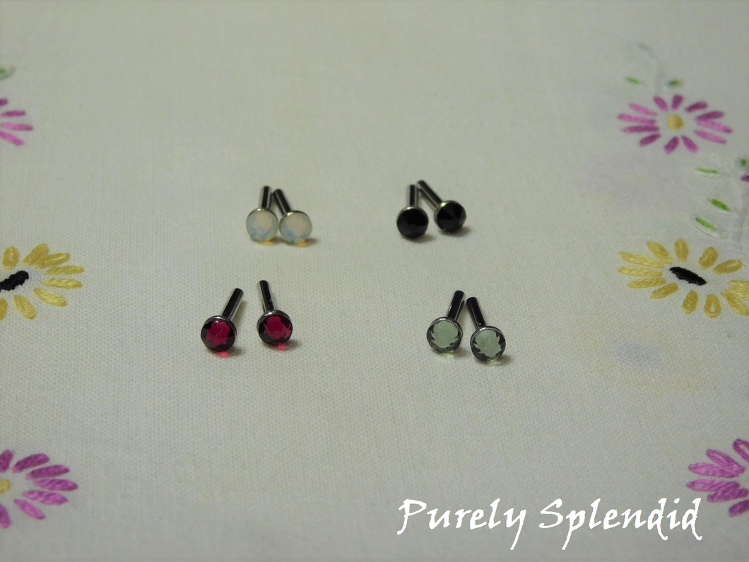 Four pairs of beautiful sparkling crystal 2mm stud earrings in Jet Black, Ruby Red, White Opal and Black Diamond (grey) for 18 inch dolls