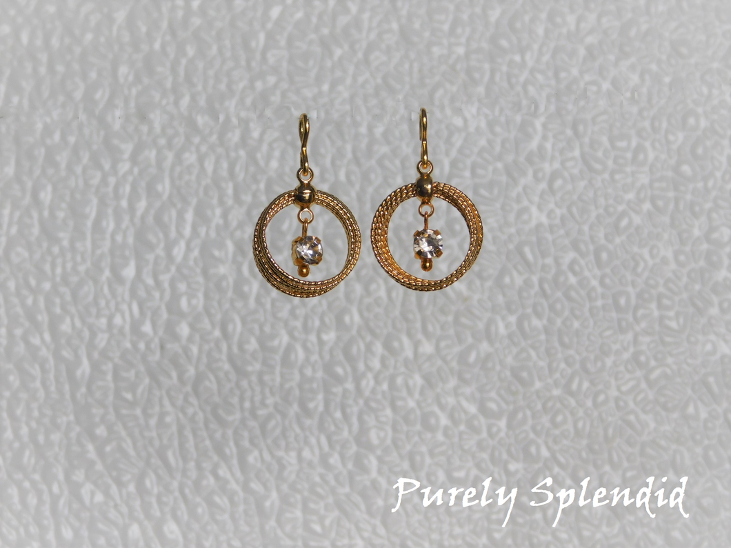 multiple textured gold loops with a sparkling center dangle make up these Multi Gold Loop Earring Dangles