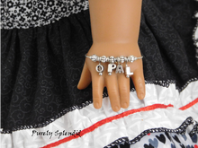 Load image into Gallery viewer, American Girl Doll shown wearing a Name Bracelet with the name Opal
