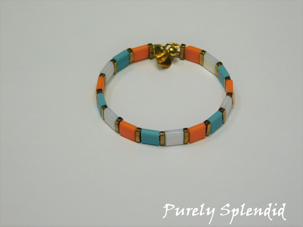 beautiful orange, turquoise and white square beads separated by slender gold beads