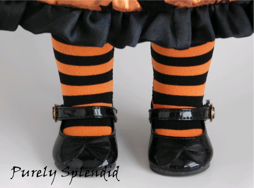 18 inch doll wearing a pair of Orange and Black Striped Tights