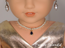 Load image into Gallery viewer, 18 inch doll shown all dressed up wearing a string of white pearls with a sparkling blue center pendant
