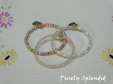 Load image into Gallery viewer, Set of three Garden Party Stacking Bracelets on a white floral background
