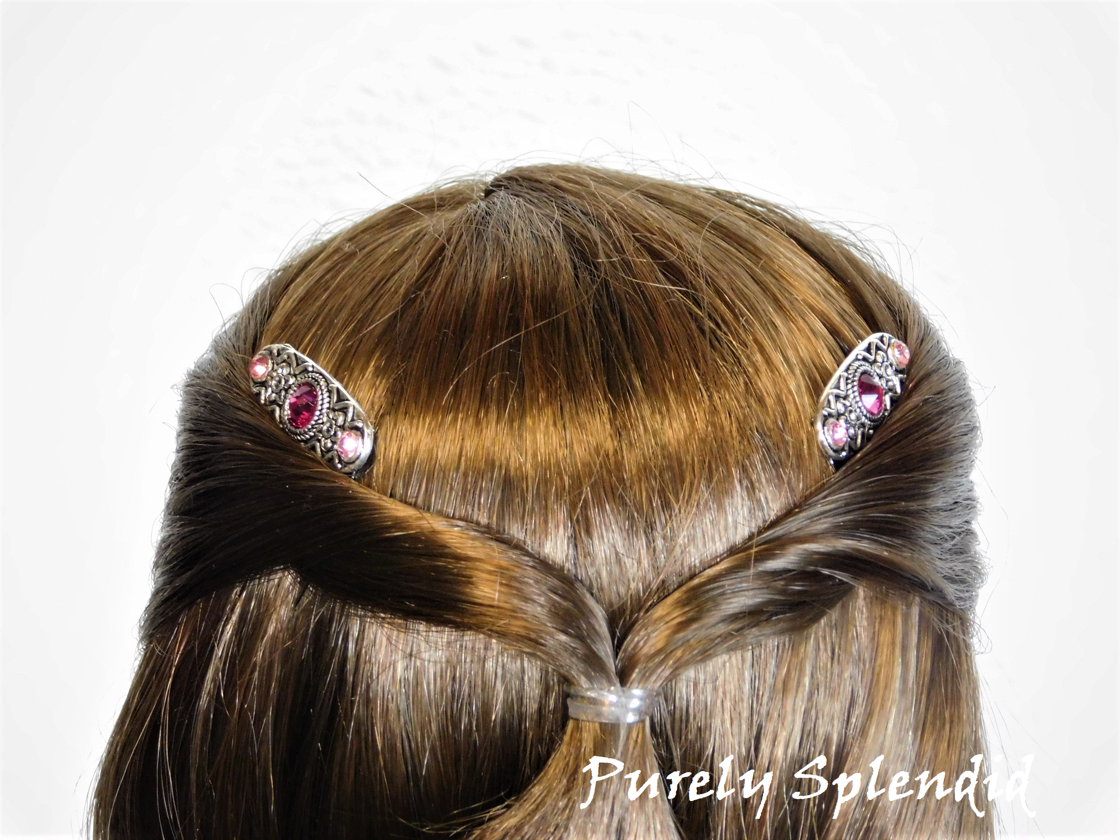 18 inch doll shown from the backside wearing a pair of the Sparkling Pink Hair Combs in her hair
