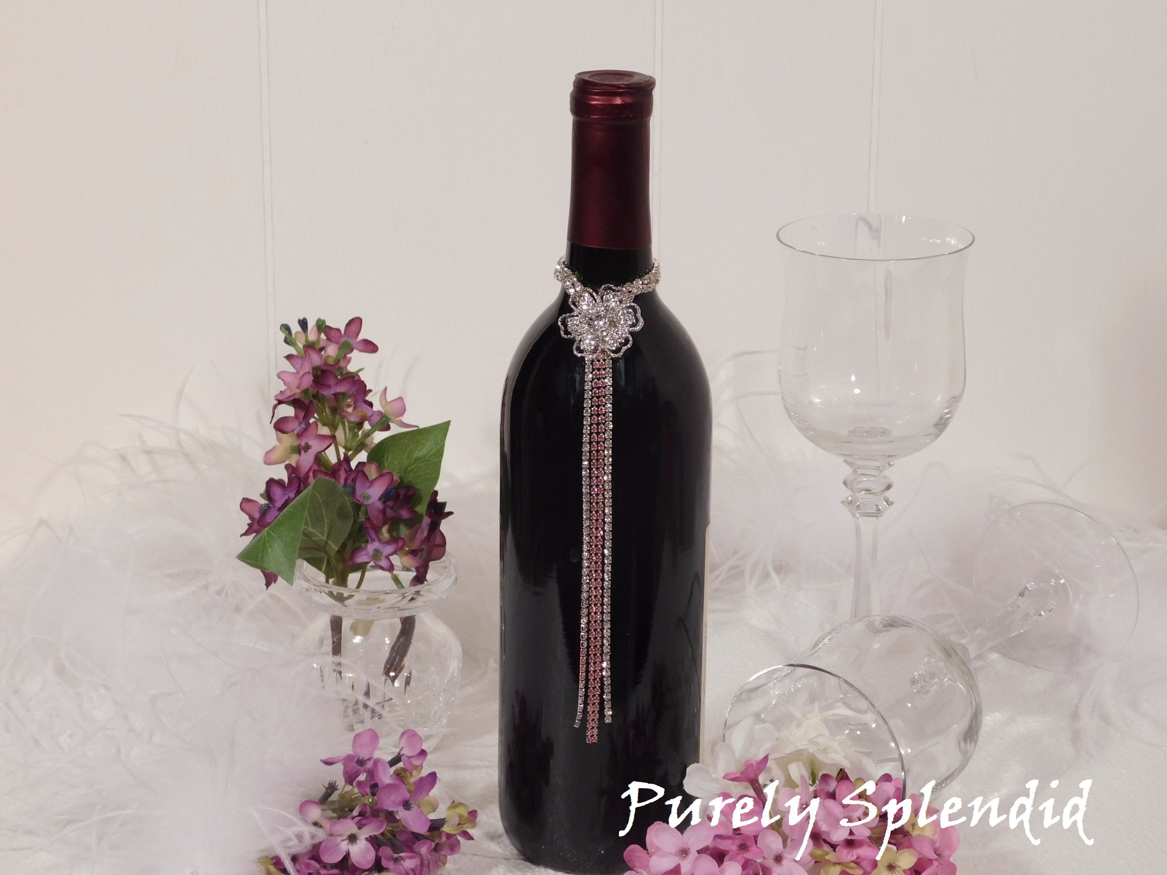 Sparkling Rhinestone Flower Bottle Bling with Pink Accents shown on the neck of a standard size wine bottle