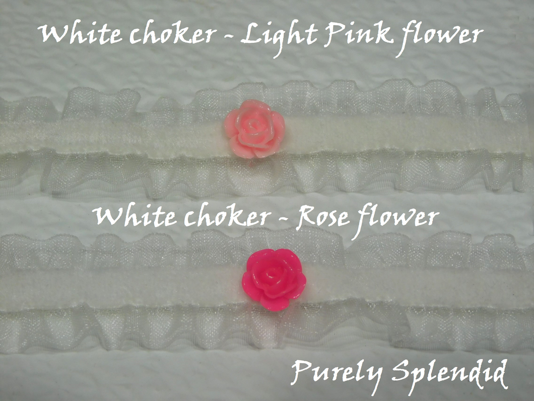 two lacy white velvet chokers shown one with a light pink center flower and the other with a rose colored centered flower