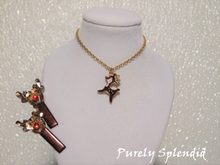 Load image into Gallery viewer, Two brown hair clips each with a 3D Rudolph Reindeer head and a full body brown and white Rudolph Reindeer charm on a gold chain necklace shown on a white background
