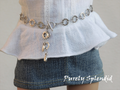 flat silver colored "o"s that have a hammered look to them make up this Silver Circle Chain Belt. Shown on an 18 inch doll