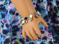 flat silver diamond shaped charms on a silver chain makes up this pretty Silver Shaggy Bracelet seen worn by an 18 inch doll who has a 3 1/4" wrist