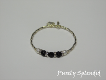 Load image into Gallery viewer, Silver bracelet with three round sparkling black beads each surrounded with a ring of sparkle
