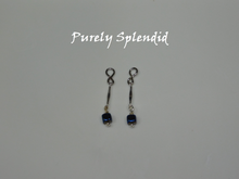 Load image into Gallery viewer, Long thin silver bead with a dark blue square bead dangling below. Shown on a white background
