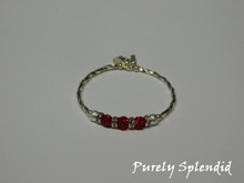 Load image into Gallery viewer, Silver bracelet with three round sparkling red beads each surrounded with a ring of sparkle

