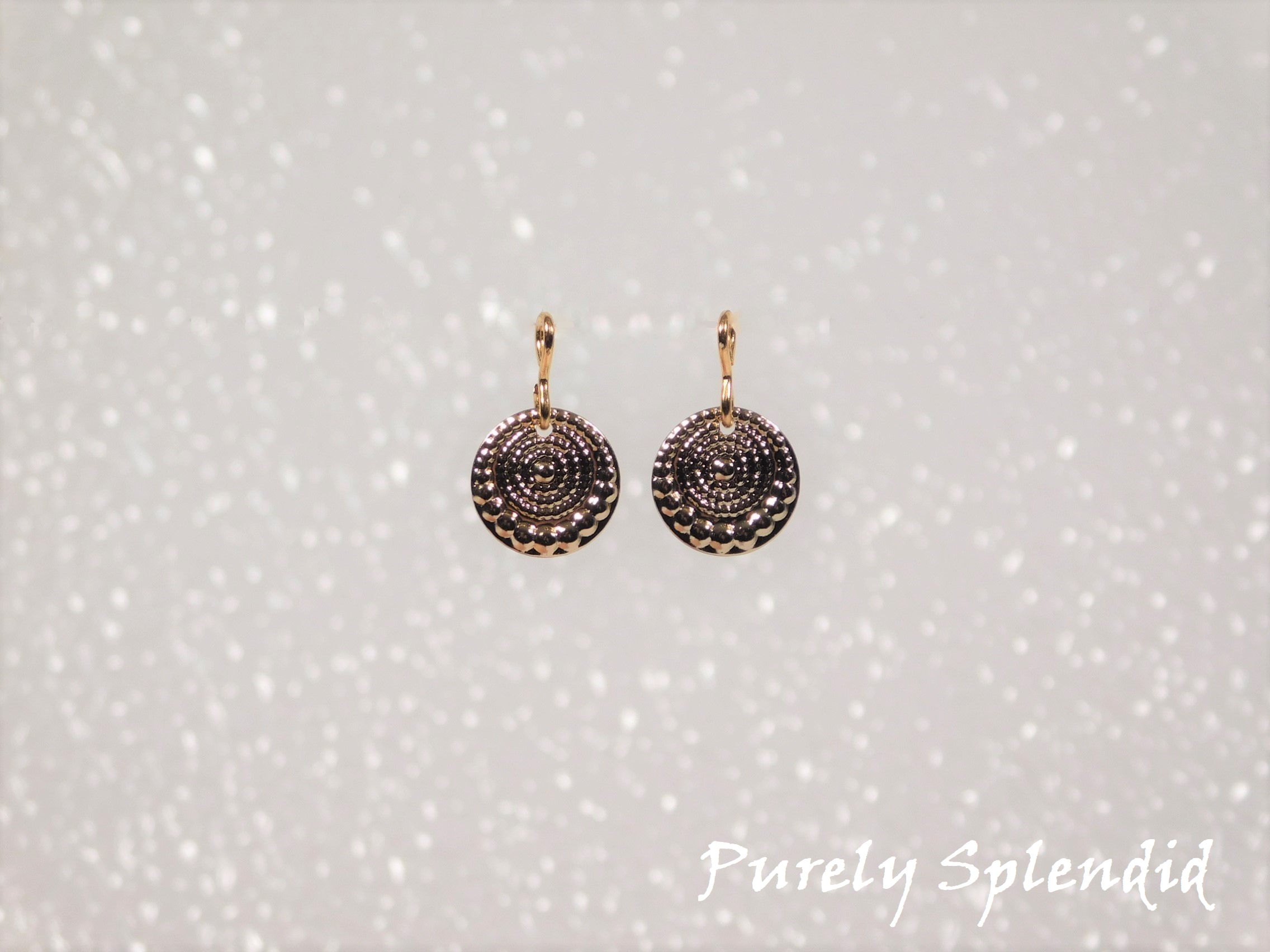 small round gold medallions with a circular raised pattern shown on a white background