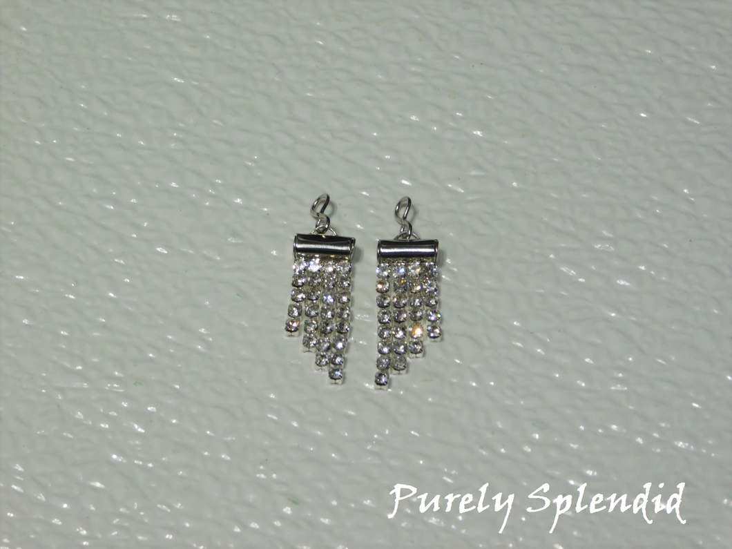 four rows of sparkling silver rhinestones hanging from the main earring dangle with a slanted bottom edge.