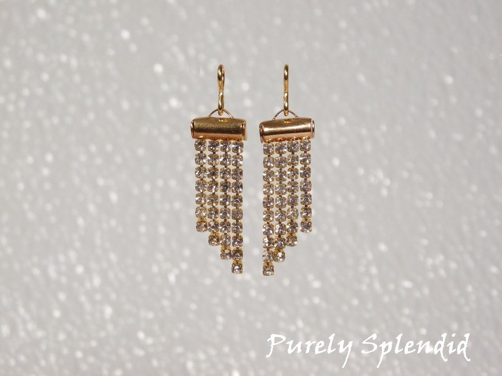 four rows of sparkling gold chain dangling from the earrings