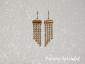 four rows of sparkling gold chain dangling from the earrings