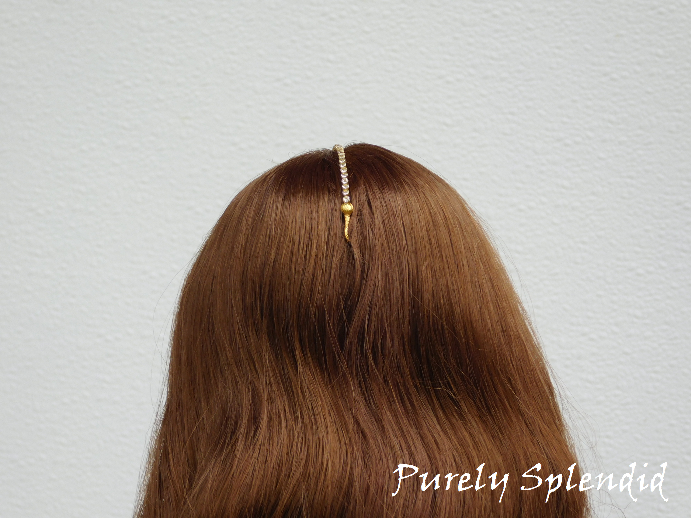 18 inch doll shown with the Maang Tikka hooked into her hair in the back of her head