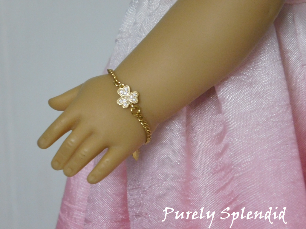 18 inch doll shown wearing a Sparkling Golden Shamrock Bracelet