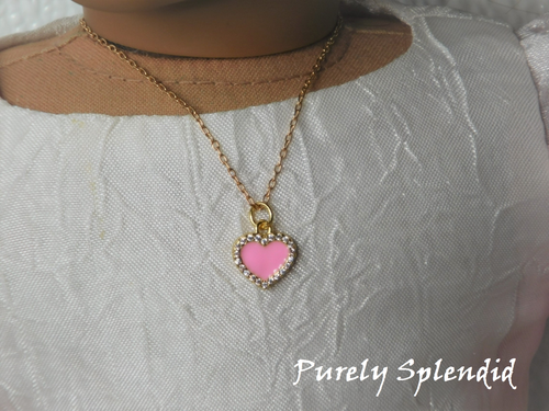18 inch doll shown wearing a Pink Heart necklace outlined with sparkling cubic zirconia crystals