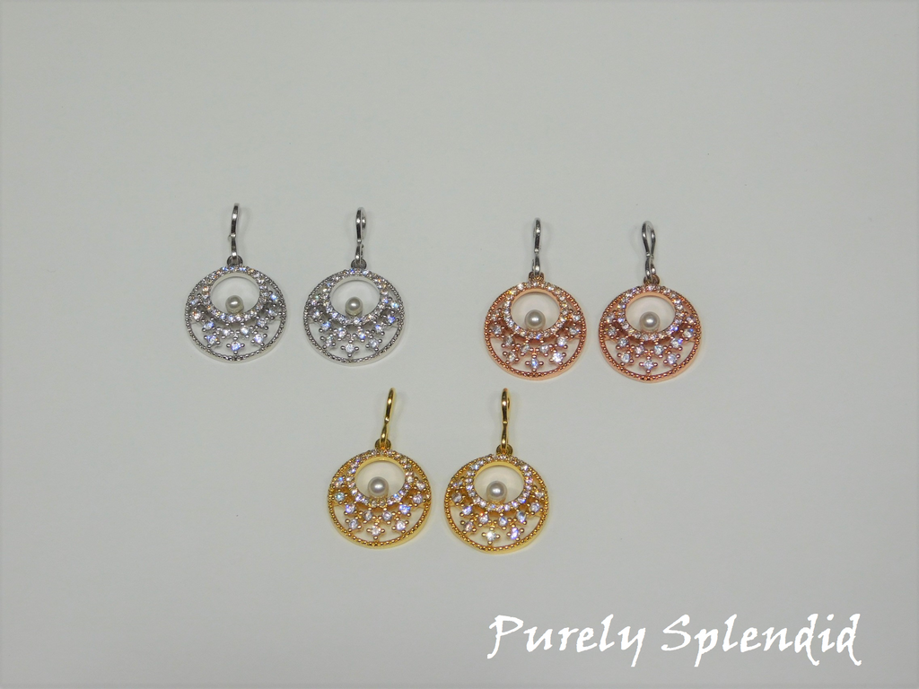 three pairs of Sparkling Indian Pearl Earrings shown on a white background. Color choices are silver, gold and rose gold. Dangles are round with an open center. They have sparkling rhinestones all around and one lone white pearl in the center