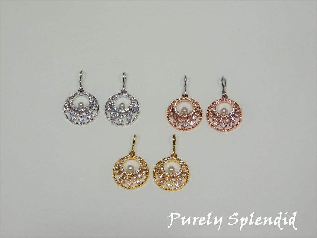 three pairs of Sparkling Indian Pearl Earrings shown on a white background. Color choices are silver, gold and rose gold. Dangles are round with an open center. They have sparkling rhinestones all around and one lone white pearl in the center