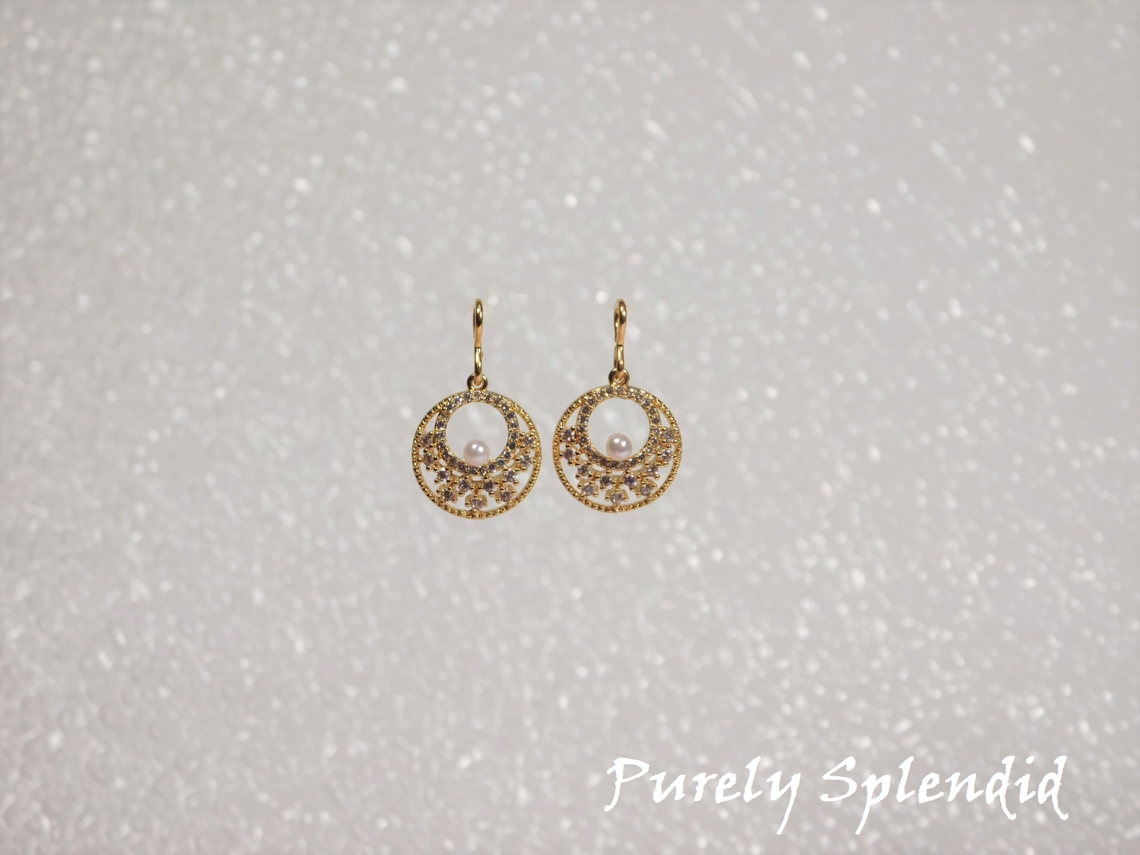 Gold colored Sparkling Indian Pearl Earrings shown on a white background