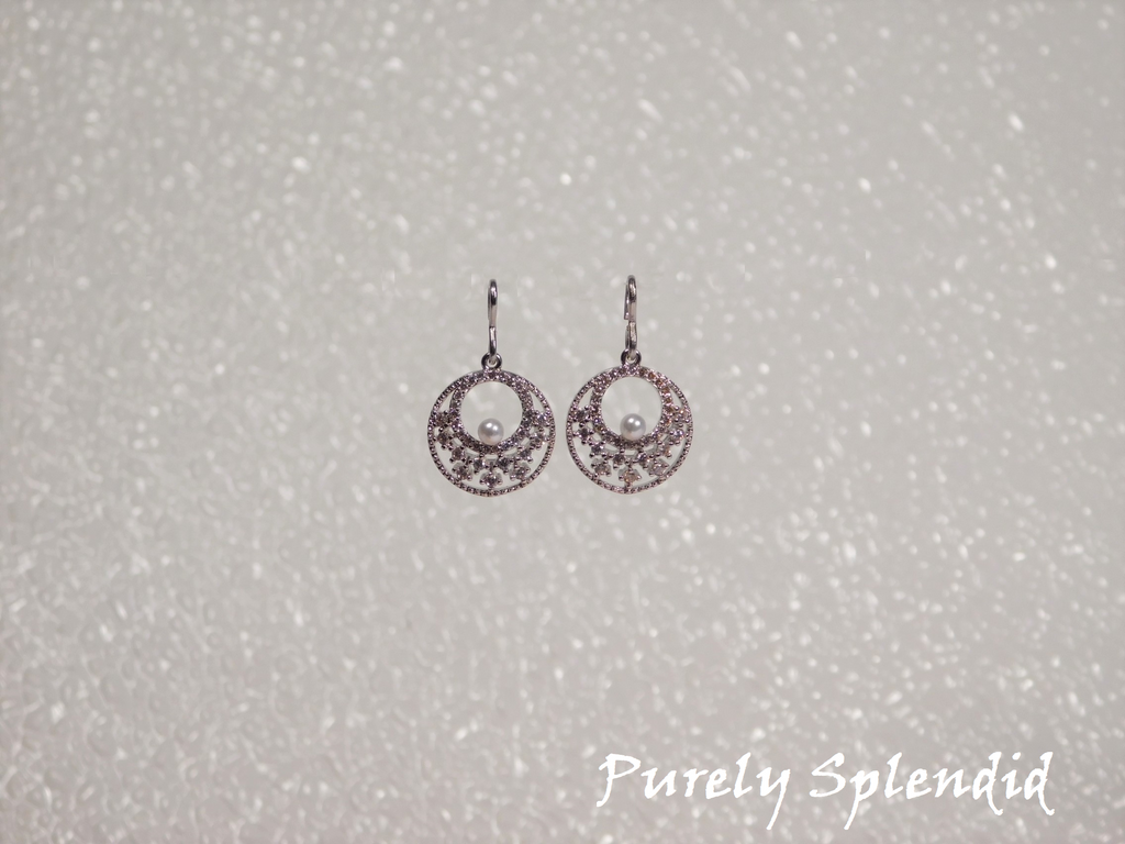 Silver colored Sparkling Indian Pearl Earrings shown on a white background