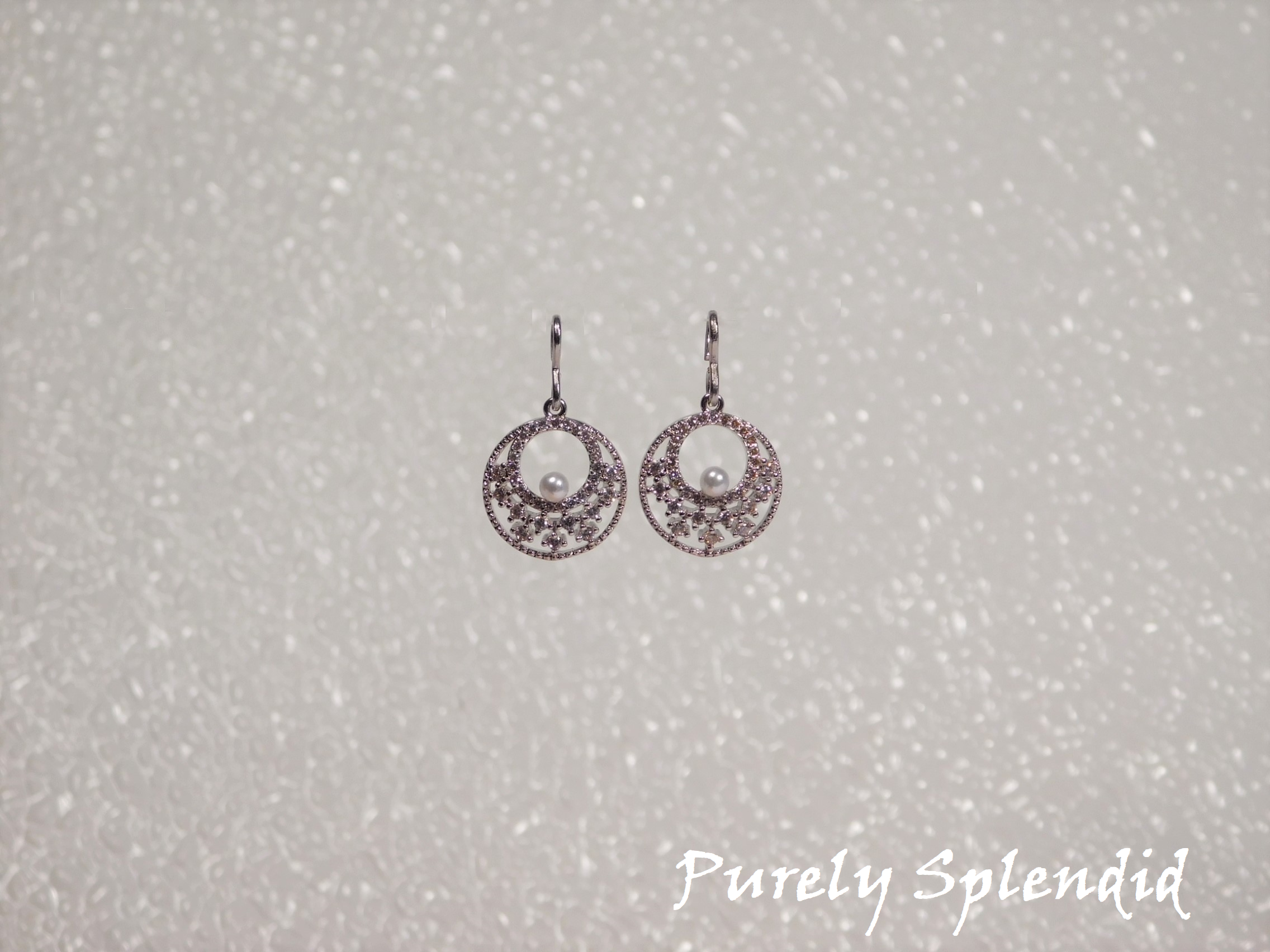 Silver colored Sparkling Indian Pearl Earrings shown on a white background