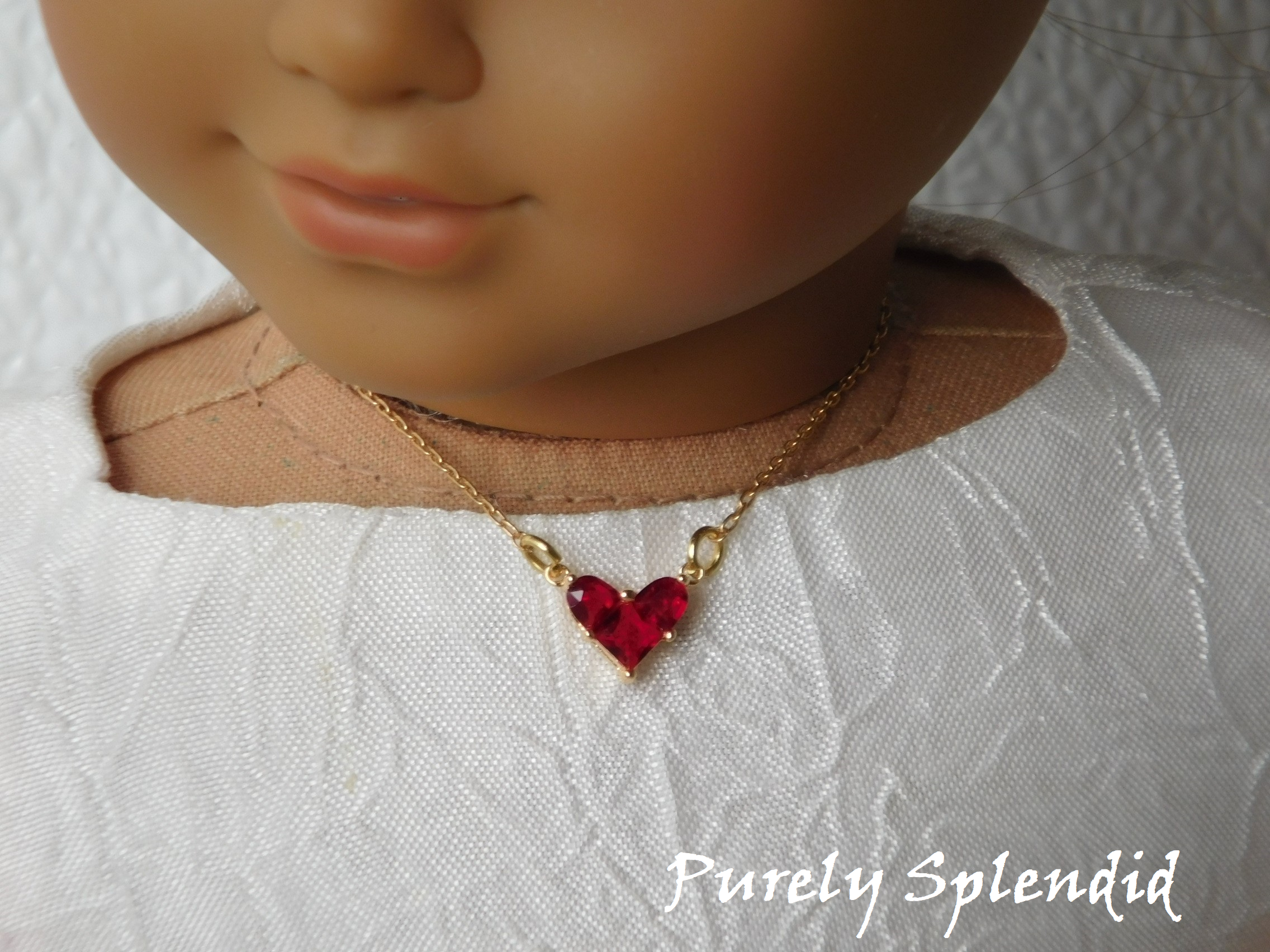 18 inch doll shown wearing a beautiful Sparkling Red Heart Necklace on a gold colored chain