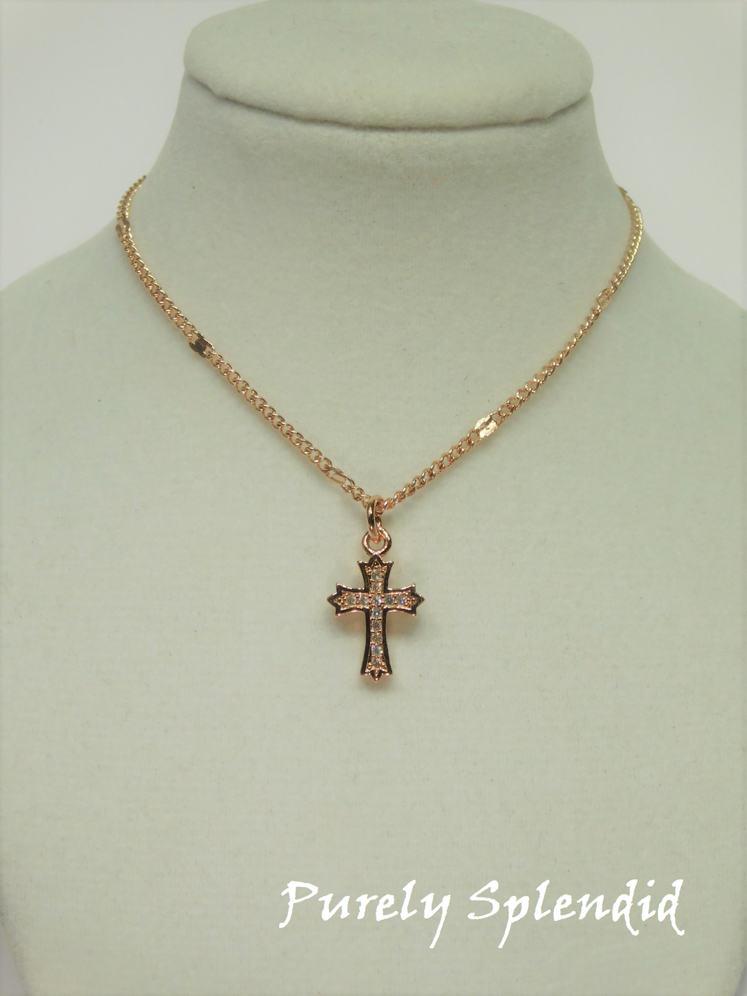 beautiful Rose Gold Cross Necklace with tiny Cubic Zirconia sparkles, hanging from a pretty rose gold chain