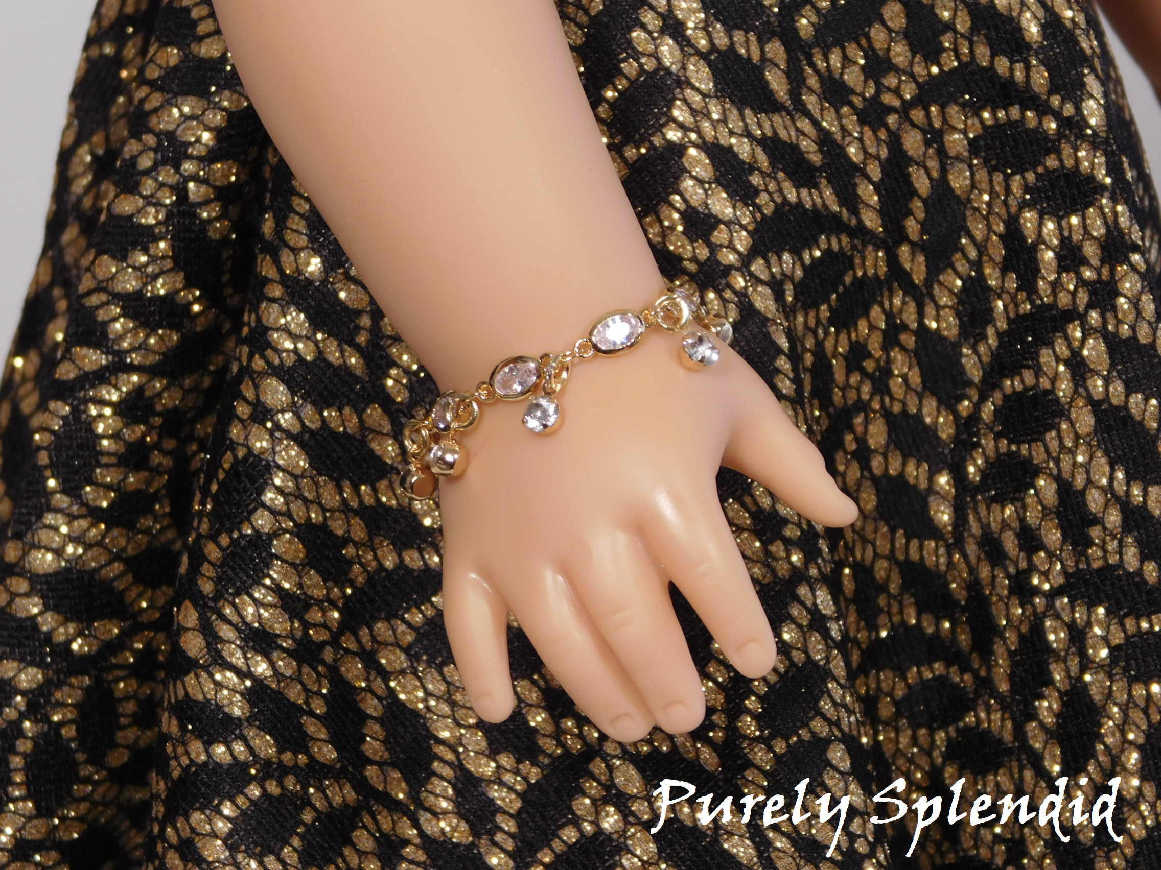 Beautiful Sparkling Royalty Bracelet shown on an 18 inch doll. Bracelet matches the necklace- Crystal chain, with round rhinestone crystal hanging all around the chain.