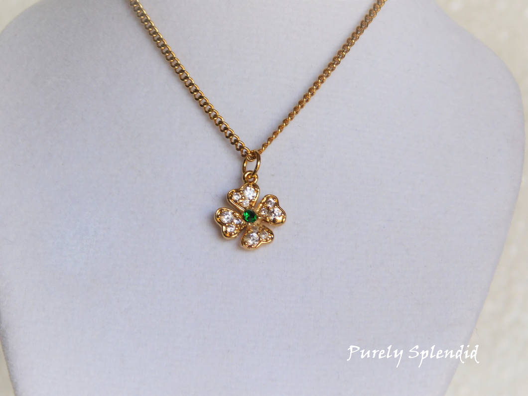 Beautiful cubic zirconia clear crystals make up this pretty four leaf shamrock with a green center stone 
