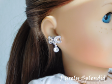 Load image into Gallery viewer, Crystal Bow Stud Earrings shown on an 18 inch doll
