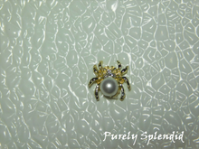 Load image into Gallery viewer, A large faux pearl makes up the body of this Spider Brooch.

