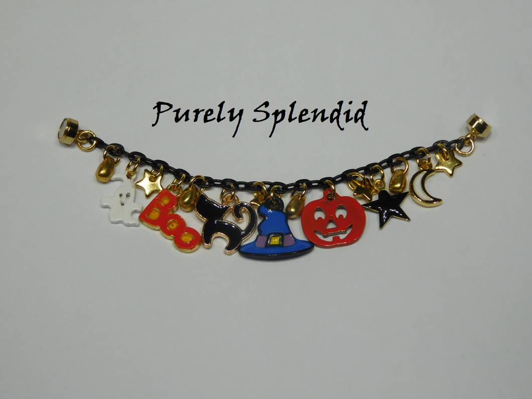 Spooky Halloween Charm Bracelet features white ghost, orange word BOO, black cat, blue witch hat, orange pumpkin, black star and white moon charms and a magnetic closure