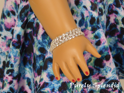 Three rows of silver colored rhinestones make up this Triple Silver Rhinestone Bracelet, as shown on an 18 inch doll who has a wrist measuring 3 1/4