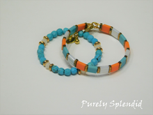 Load image into Gallery viewer, set of two Stylish Stacking Bracelets - one with orange, turquoise and white squares separated by a touch of gold. The second bracelet has dimentional  turquoise beads and white beads flanked by a touch of gold beads
