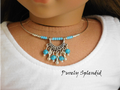 18 inch doll wearing a Tribal Choker Necklace  which consists of a wire necklace with turquoise and silver colored beads. The focal point is a "u" shaped silver colored dangle with turquoise and silver dangles hanging from it.