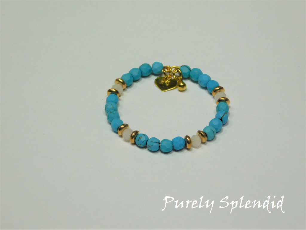 beautiful turquoise colored beads with white beads surrounded by slender gold beads