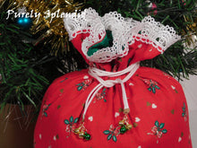 Load image into Gallery viewer, close up of the pretty white lace edging the top of the gift bag and the white drawstrings with 3 small jingle bells hanging from each end of the drawstring
