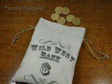 Load image into Gallery viewer, Wild West Bank bag shown laying down open with six golden wooden coins
